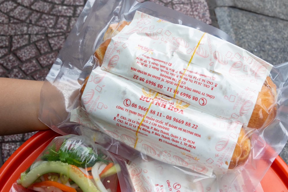 The shop offers free vacuum sealing and box packaging for customers who want to transport banh mi over long distances